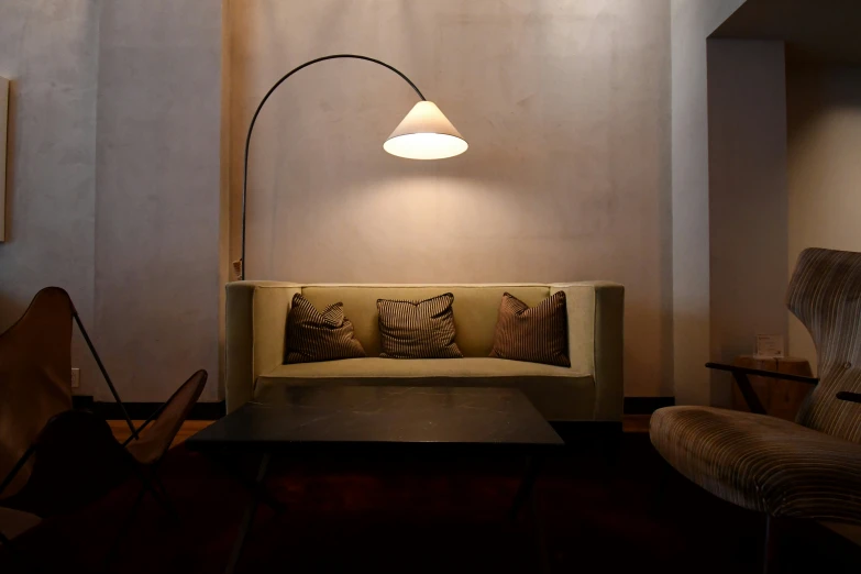 a light is hanging above a small couch