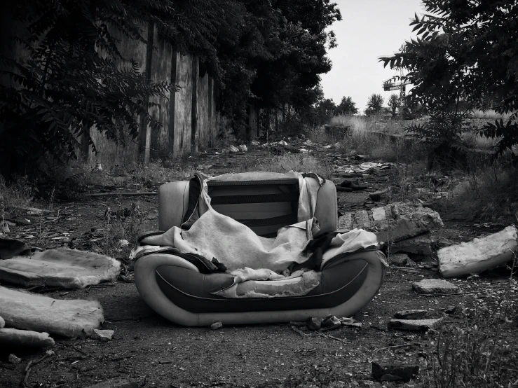 an inflatable chair is covered in blankets on the ground