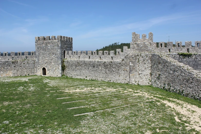 a tall castle with towers is shown on a sunny day