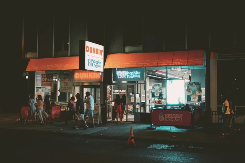 people are lined up outside of a restaurant at night
