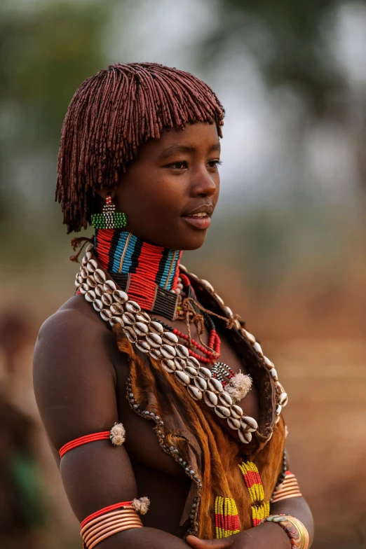 young african girl in head dress with neck chains on