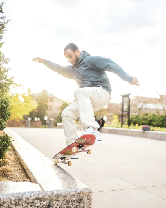 a young man doing skateboard tricks off a ledge