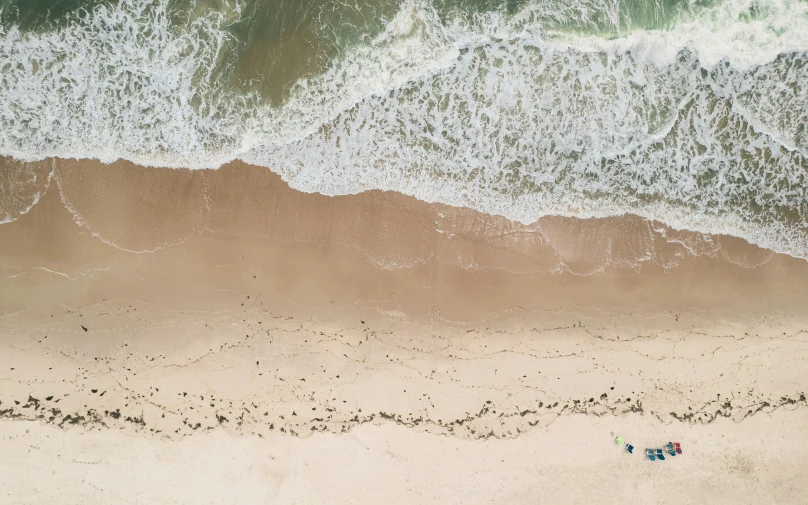 an aerial view of a beach with water