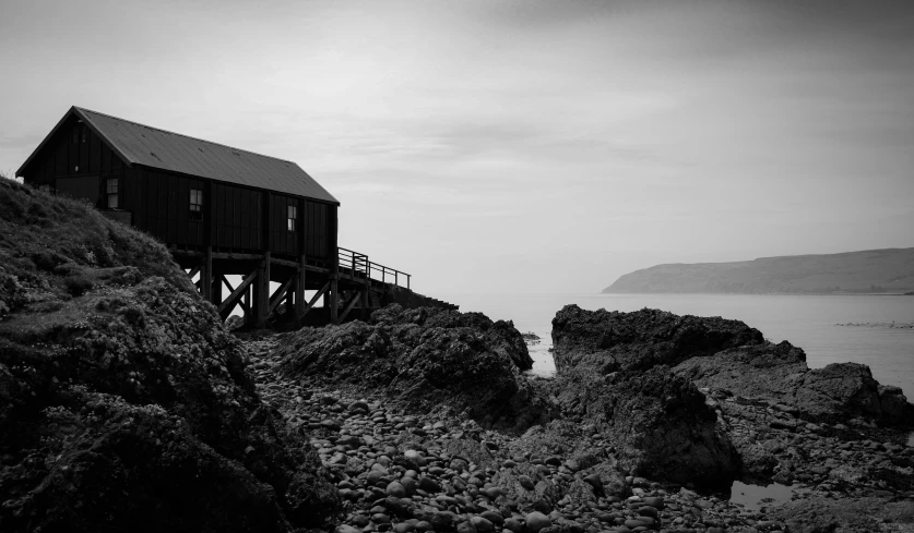 a lonely wooden cabin near the shore of a sea