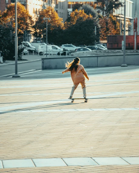 a person skateboarding down a walkway near a city