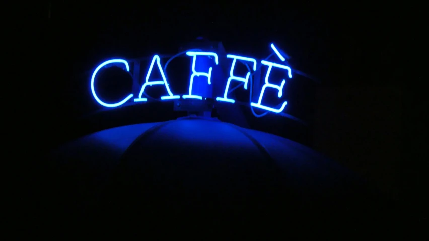 blue neon sign above a dark lit restaurant