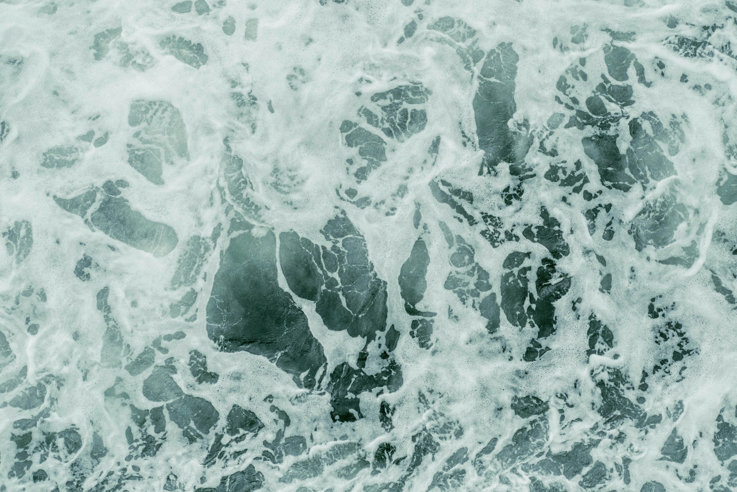 a black and white po of water with rocks in it