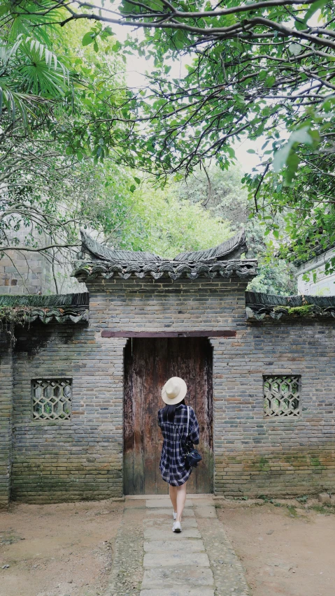 a woman walking into an abandoned building