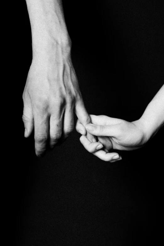 two people holding hands next to each other