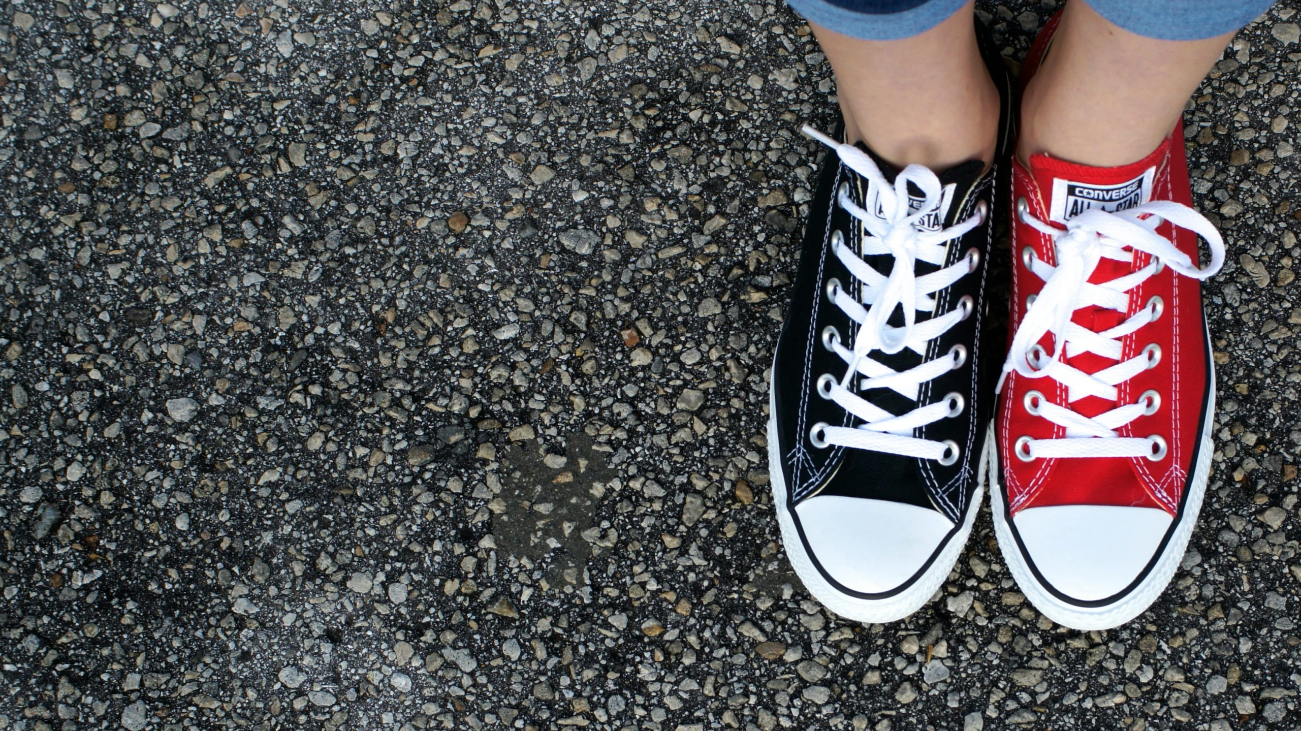 a person wearing black and red tennis shoes