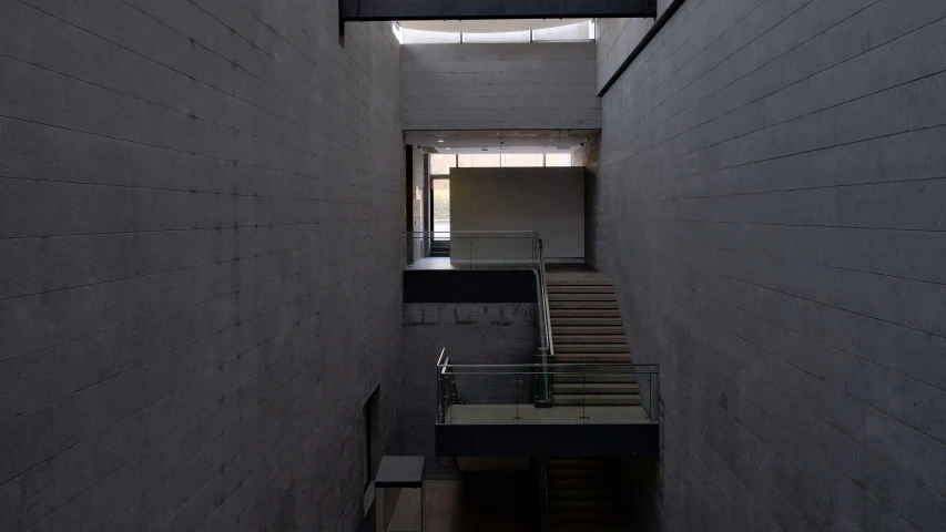 the stairs are lined up along a wall with a light coming through it