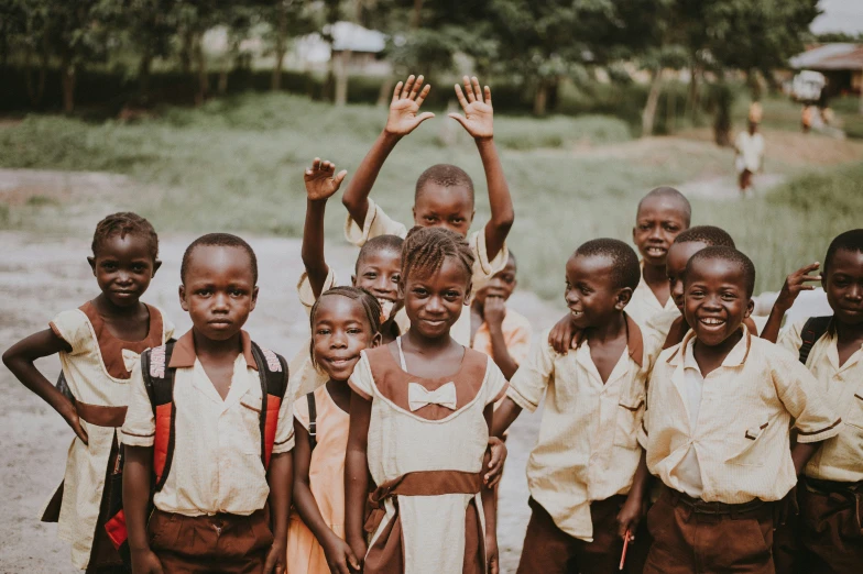 several children stand in a row and pose for a po