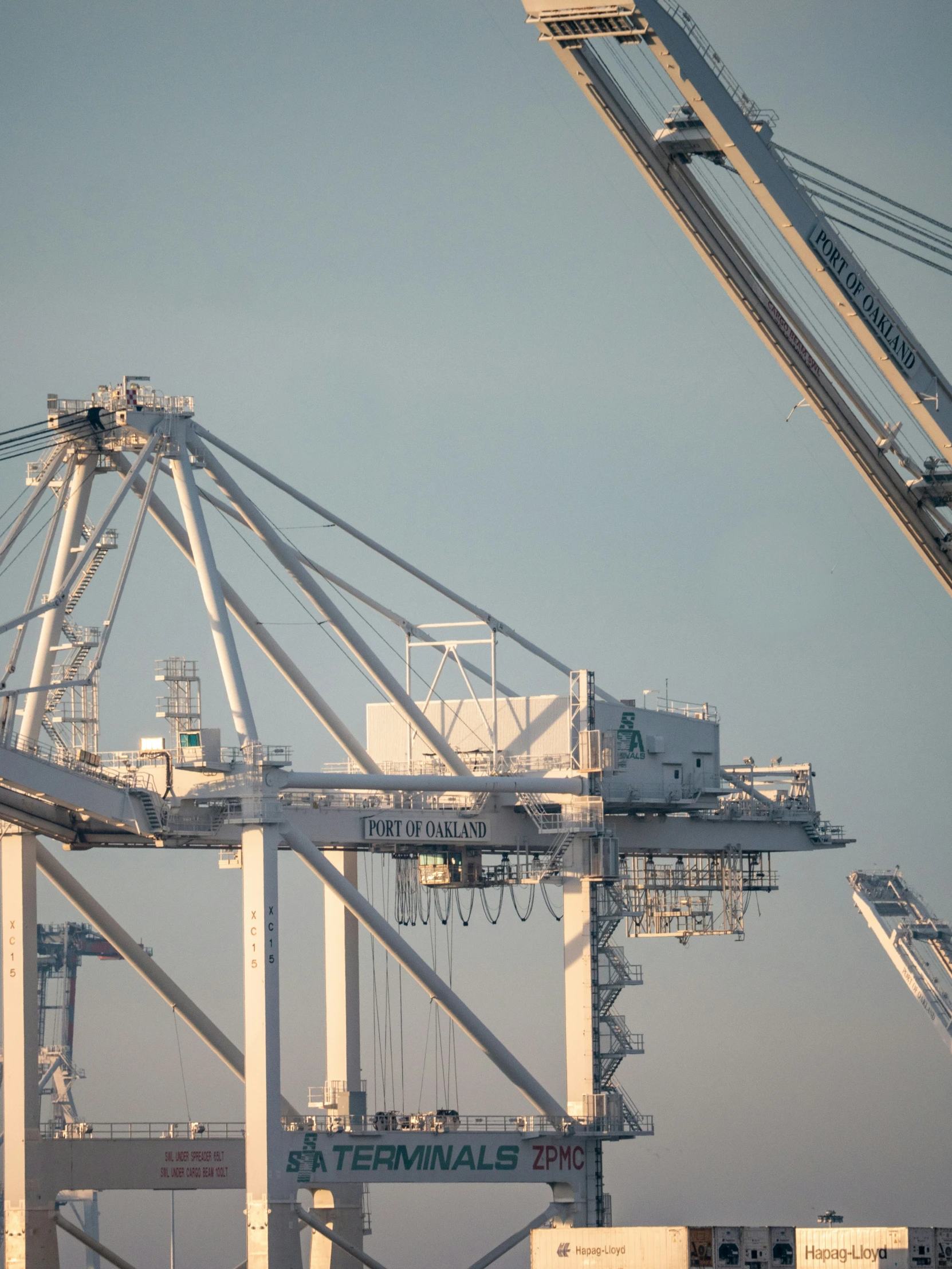 a very tall white tower with some cranes