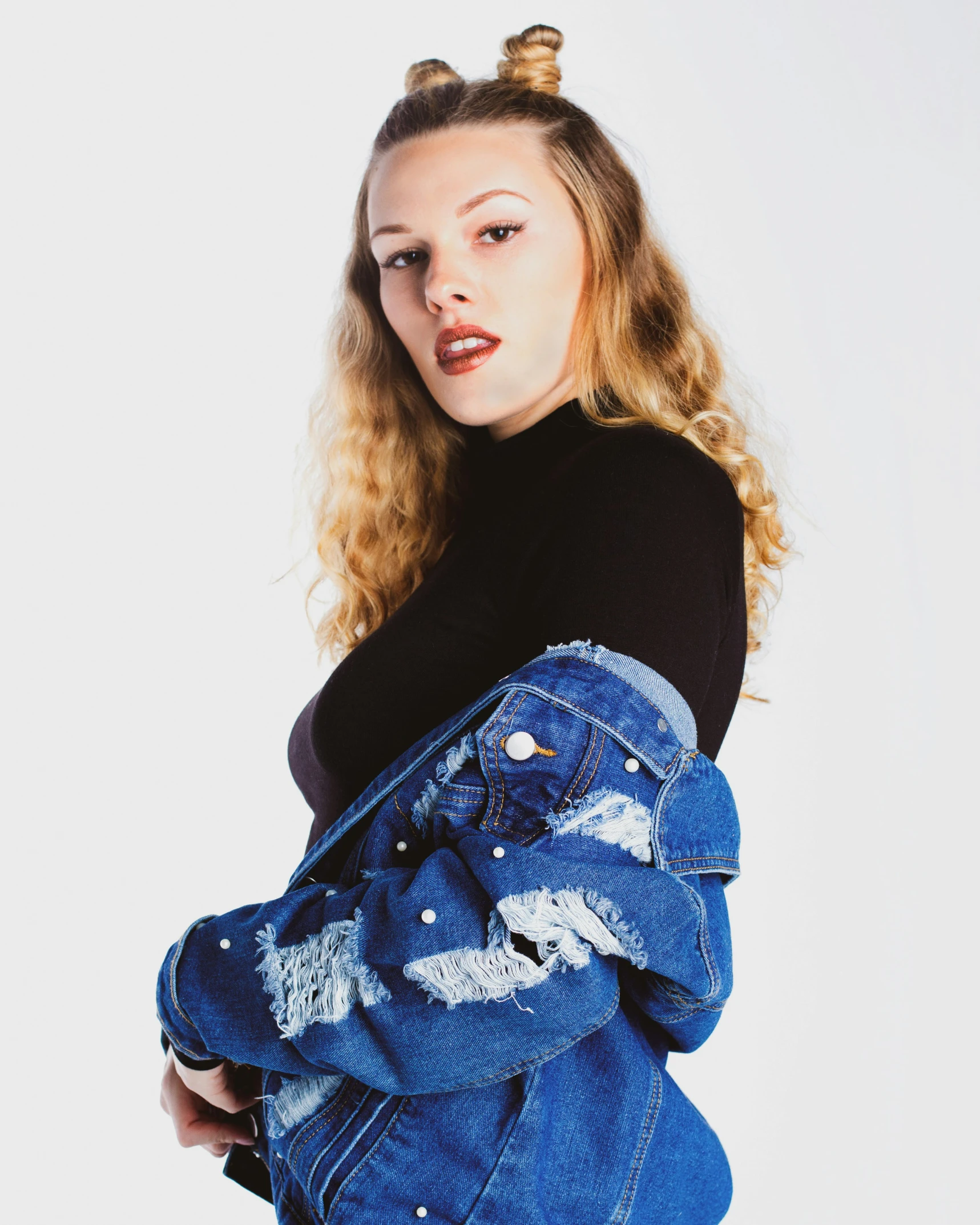 girl in black shirt and blue jean jacket posing