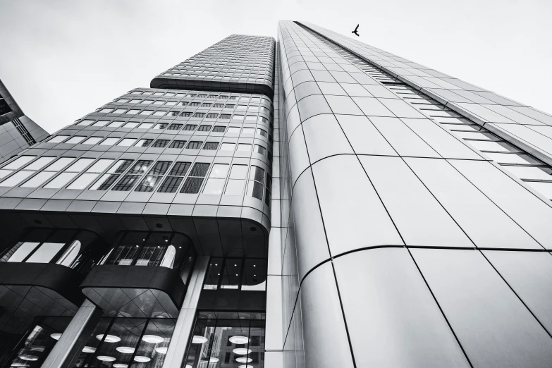 a tall building is against a partly cloudy sky