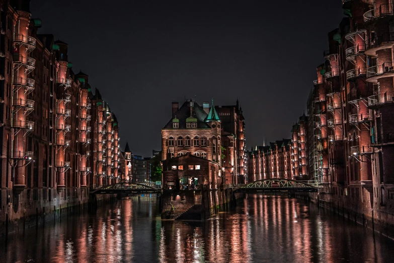 a view of many buildings and a body of water at night