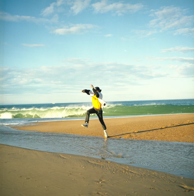 man on the beach in action with his hat on