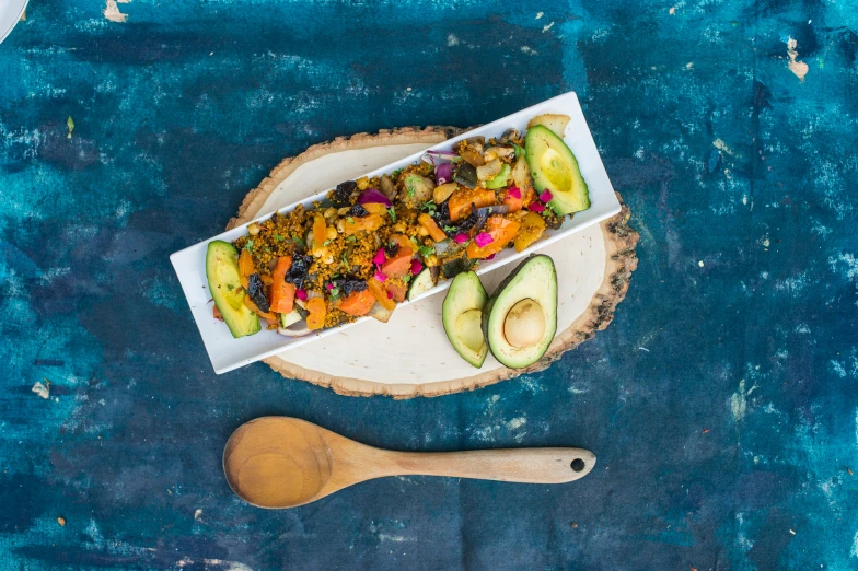 an open tray with cut into wedges and vegetable mixture on a blue table cloth