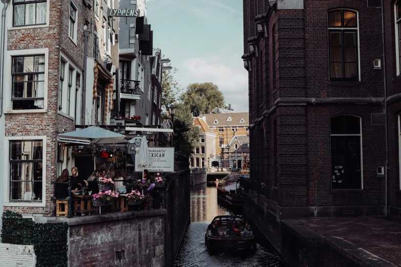 two boats going down a canal near buildings