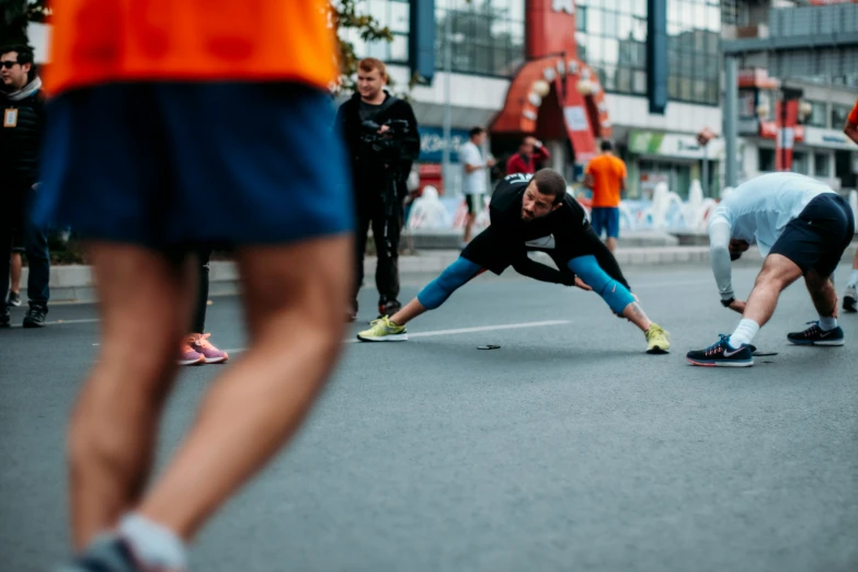 people are doing exercises while walking in a street