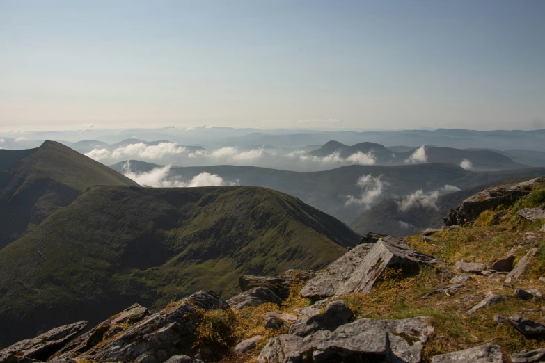 the view from a high hill shows rolling mountains