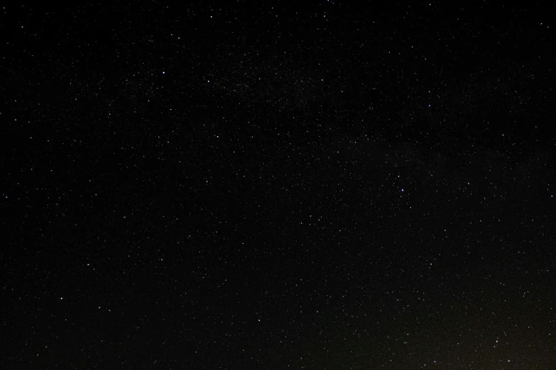 several stars in the night sky above some trees