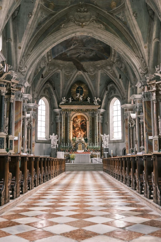 a room with a large checkered floor that leads to a cathedral