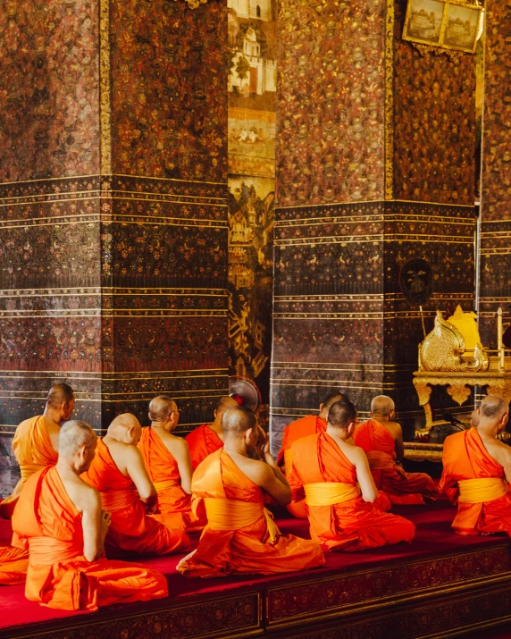 a group of monkies are sitting together in an asian style room