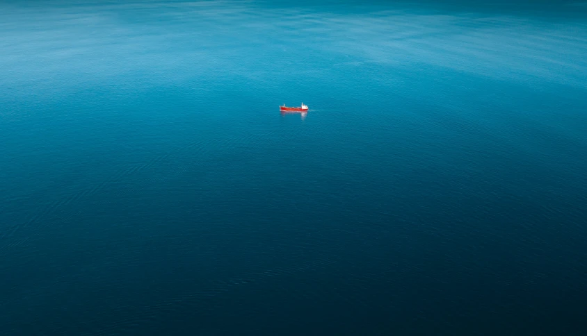 an aerial view of a boat in a big body of water