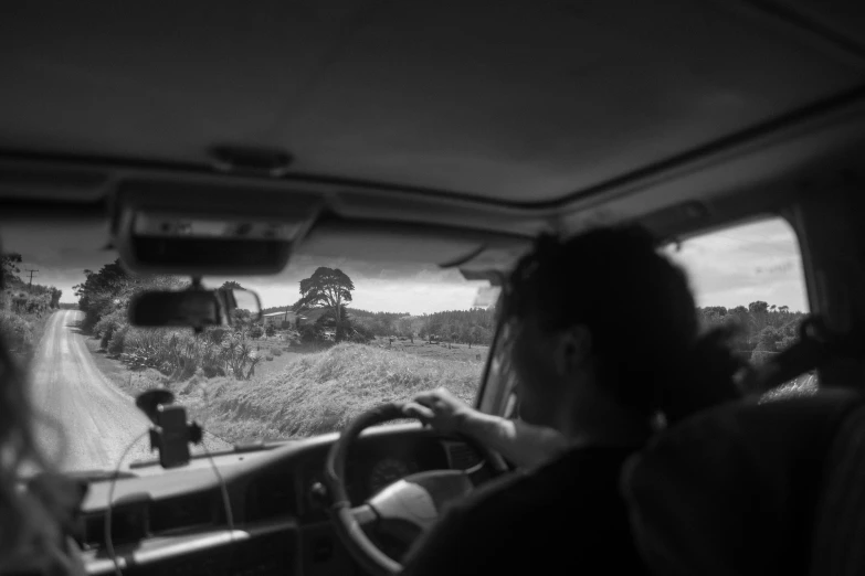 the view from inside a car looking down the road