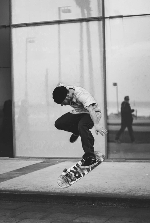 a skateboarder attempts a jump outside a building