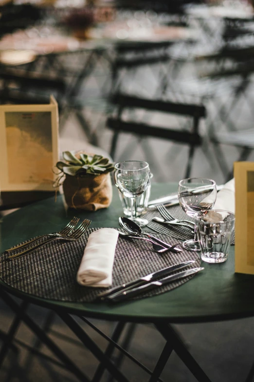 two place settings with utensils are displayed on a table