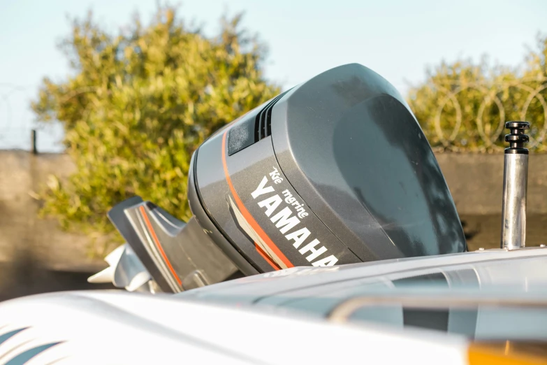 a yamaha motor boat is parked in the driveway