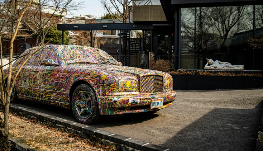 a large car parked on the side of the road covered in colored things