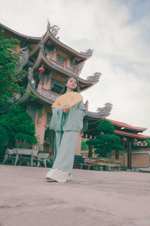 the woman in the long gown is posing for a picture