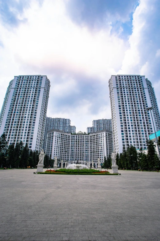 two tall buildings sitting in the middle of a parking lot