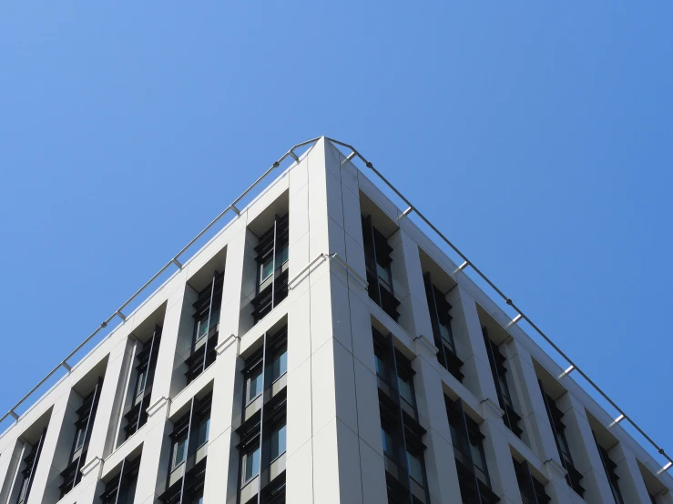 a tall building with windows and a fence around it