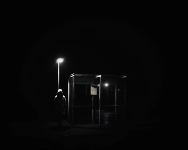 this is the side of a bus stop in the dark