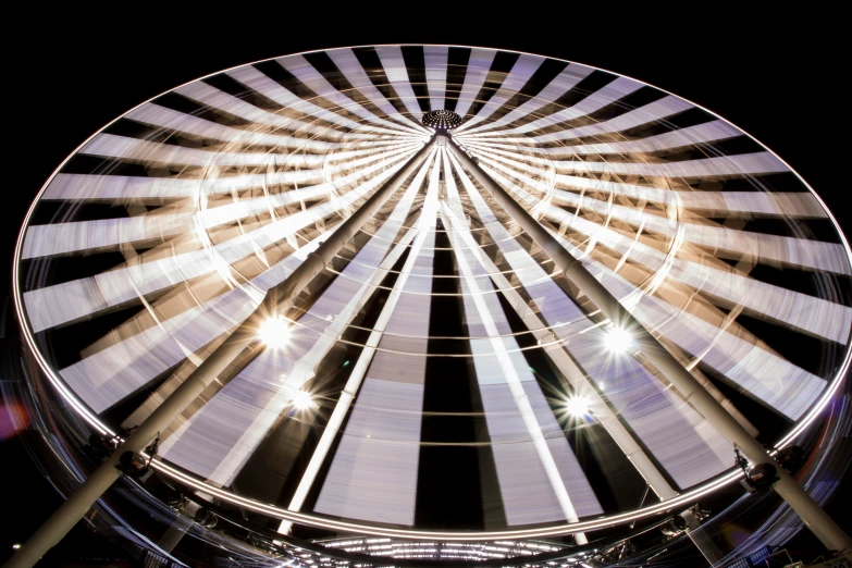 a ferris wheel that is at night with the lights on