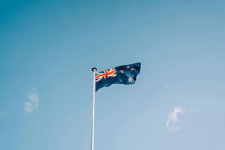 a british and a canadian flag on a flagpole