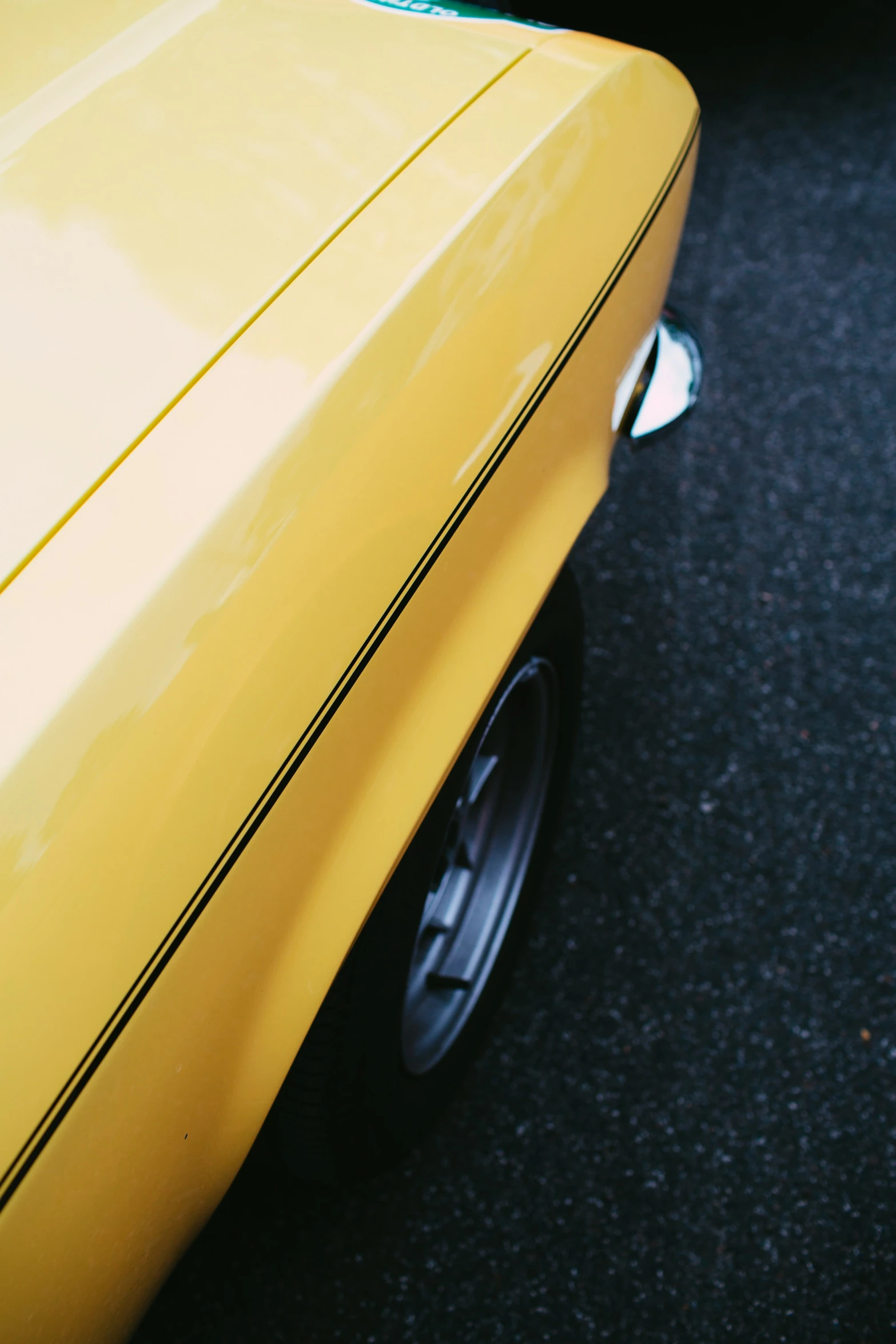 the view of the rear end of a yellow car