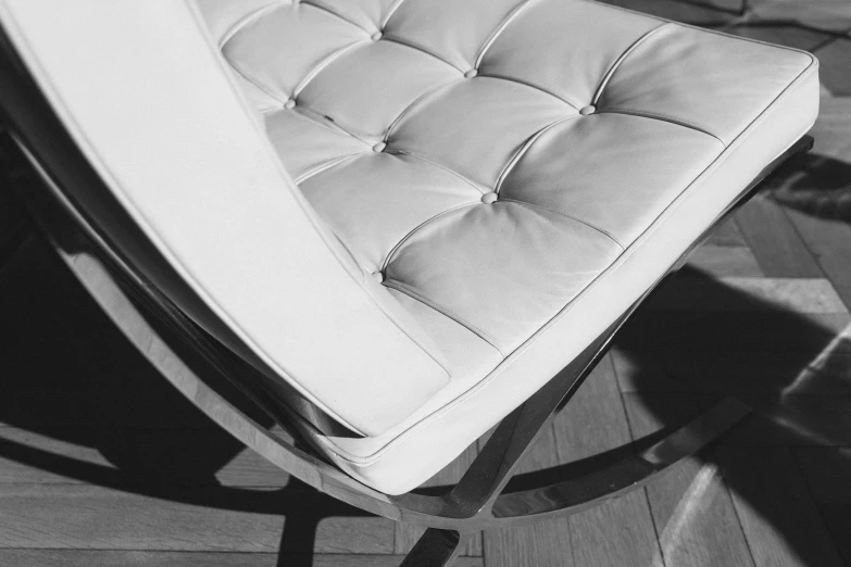 an upholstered chair sits alone on the wood floor