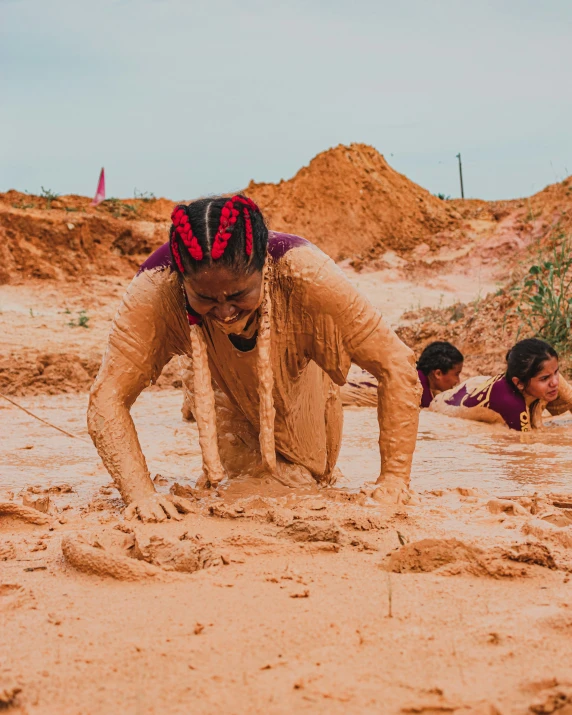 some people play with sand in the middle of the day