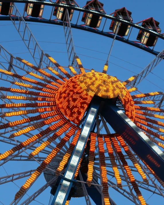 a ferris wheel with many orange lights on top