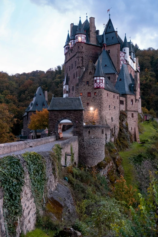 a castle near some water, near a hill