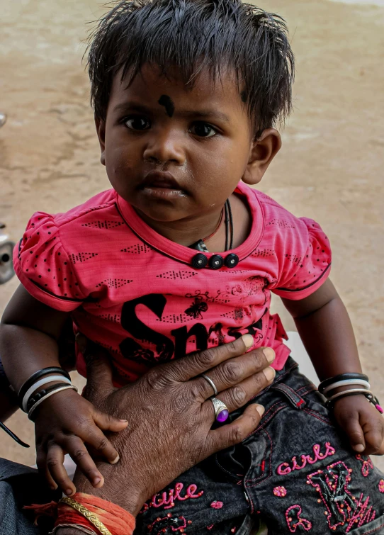 a black child holding an older woman