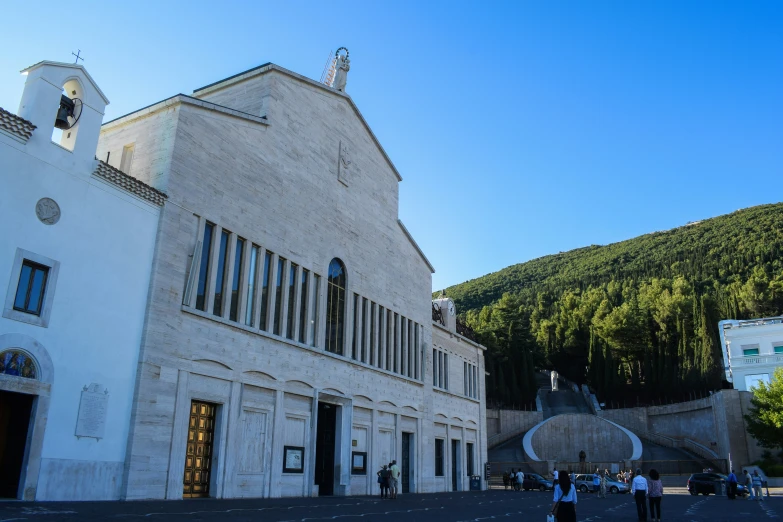 a large church and several people near by