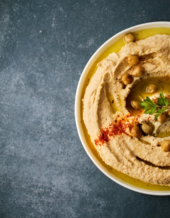 hummus in a white bowl on a table
