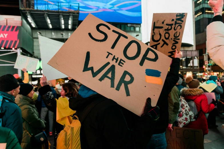 people holding signs at an event in the city