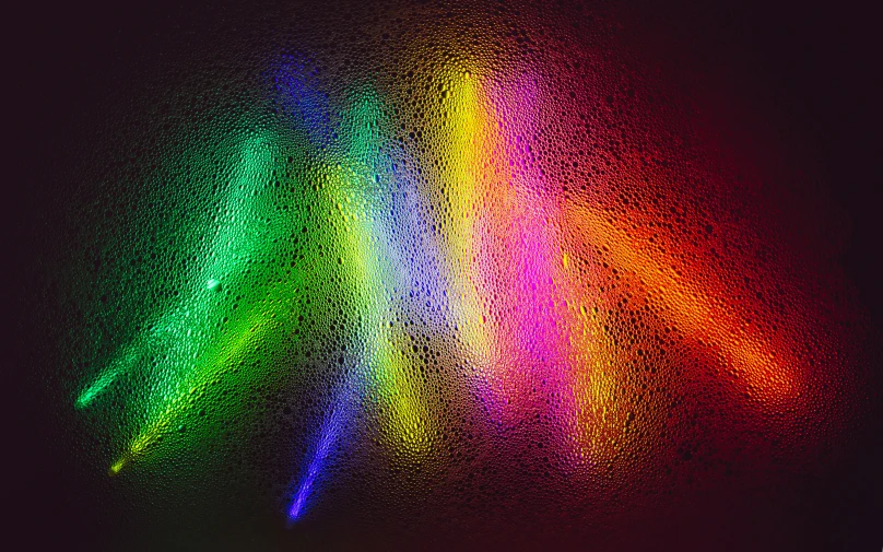 a multi - colored piece of paper is shining brightly